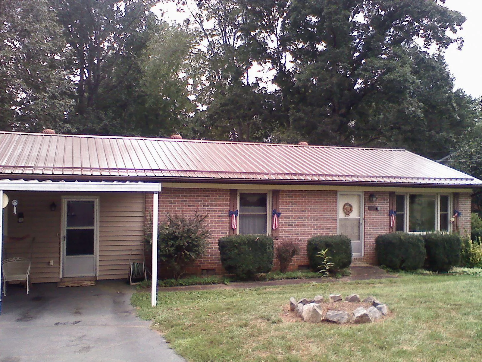 Bronze metal roof and carport on a brick ranch home — Roof Repair work by our crew in Elma